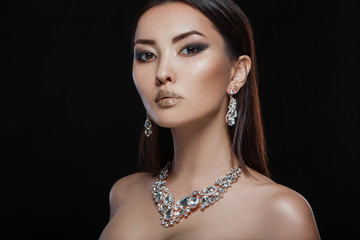 Fashion portrait of beautiful luxury woman with jewelry