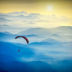 Paraglide silhouette in a light of sunrise