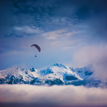 Paraglide above the snow-capped peaks