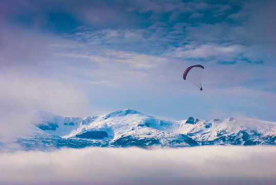 Paraglide over snow-capped peaks