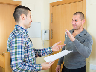 Realtor giving keys to flat owner