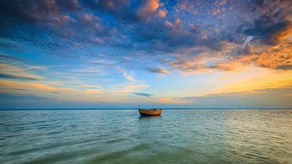 Lonely boat on the Baltic Sea at sunset. HDR - high dynamic range - obrazy, fototapety, plakaty