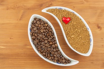 Natural coffee beans versus instant. Soluble and coffee beans on wooden background. Preparing fresh coffee. Sales of roasted coffee. Advertising for the sale of coffee.
