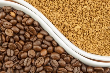 Natural coffee beans versus instant. Soluble and coffee beans on wooden background. Preparing fresh coffee. Sales of roasted coffee. Advertising for the sale of coffee.
