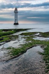 Lighthouse beacon with moody dark clouds. New Brighton, Merseyside, UK.