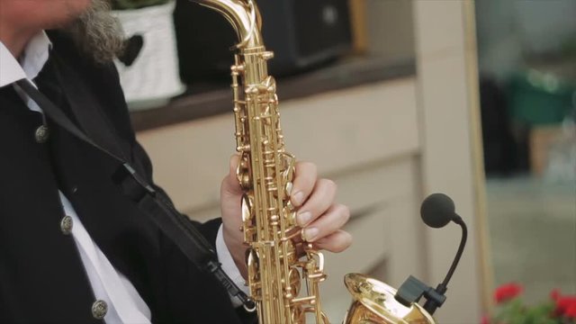 Side Shot of Male Playing Saxophone in the Street