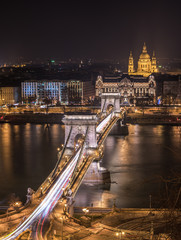 Fototapeta na wymiar Night View of Chain Bridge over Danube River and St. Stephen's Basilica in Budapest, Hungary. As Seen from Royal Palace in Buda Castle.