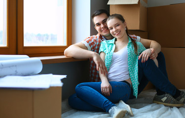 Portrait of young couple moving in new home