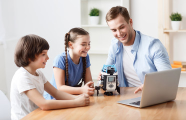 Fototapeta premium Positive father playing with kids 