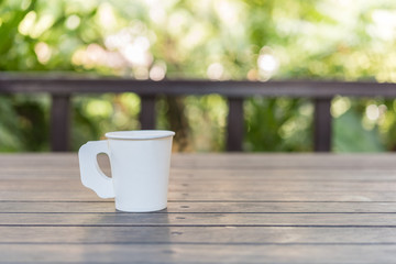 Coffee cup on wood table in cafe