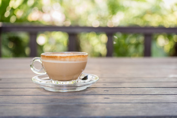 Coffee cup on wood table in cafe