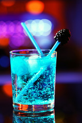 Glass of cocktail on bar background