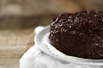 Tasty chocolate cake on wooden background