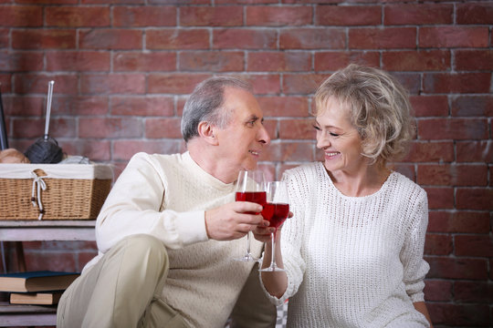 Mature Couple Drinking Wine Together At Home