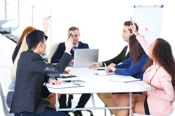 Young colleagues sitting at the business meeting in the office