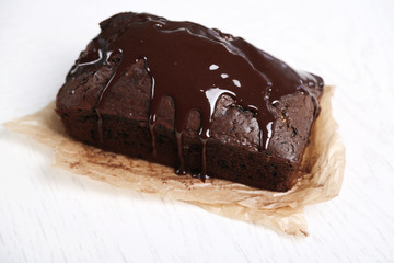 Chocolate cake with icing on white table