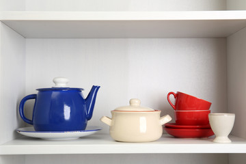 Tableware on shelf in the kitchen cupboard