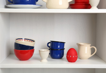 Tableware on shelves in the kitchen cupboard