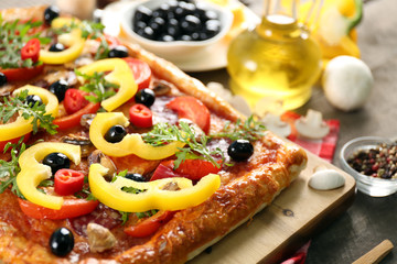 Rectangle delicious pizza and vegetables on the table, close-up
