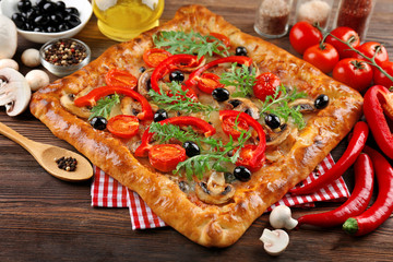 Freshly homemade pizza on wooden table closeup