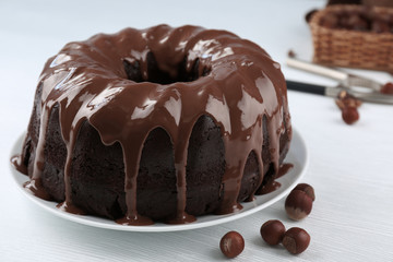 Ring chocolate cake with glaze in plate closeup