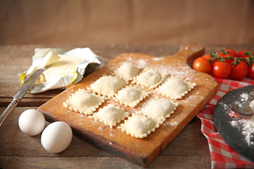 Uncooked ravioli on cutting board