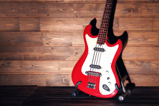 Electric guitar on dark lightened wooden background