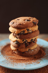 Chocolate chip cookies on plate on wooden table