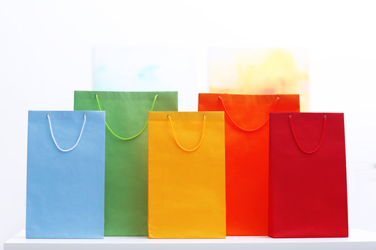 Coloured shopping bags on bright background