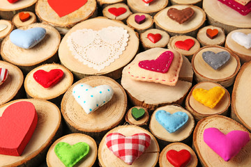 Valentine's Day concept. Different handmade hearts on wooden stumps background