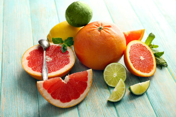 Juicy composition of tropical fruits on wooden background