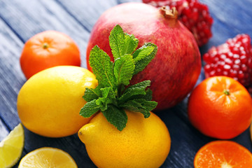 Juicy composition of tropical fruits on blue wooden background, close up