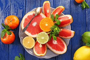 Juicy composition of tropical fruits in a bowl, close up