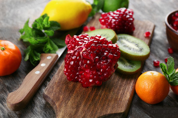 Juicy tropical fruits on wooden board, close up