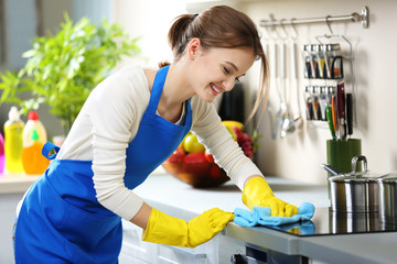 Cleaning concept. Woman washes an oven in the kitchen