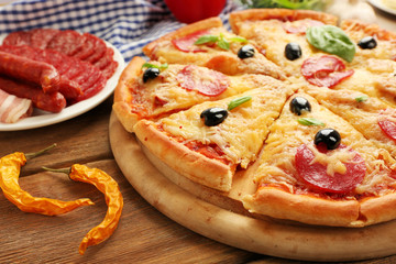 Fresh baked pizza on a wooden table, close up