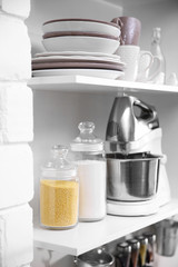 Tableware and kitchenware on a shelves