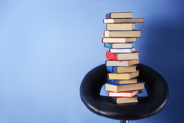 Pile of books on wall background