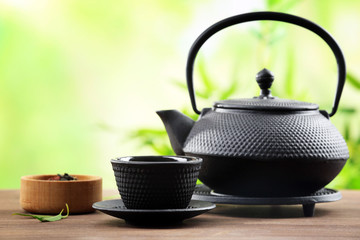 Obraz na płótnie Canvas Black pialats and teapot on blurred background