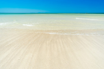 Fototapeta premium Sea and sand on the beach in blue sky.