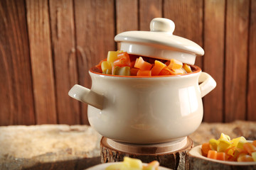 Raw pasta in pan on wooden background