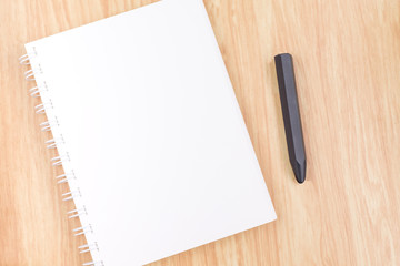 Close up blank open ring binder notebook with black pencil on wo