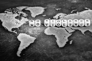 NO VIOLENCE on grunge world map, black and white