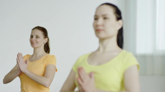 young women are practicing the Accomplished Pose 