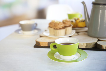 Table setting with tea and cakes indoors