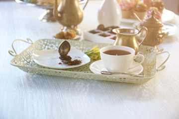 Delicious tea and cakes on wooden background