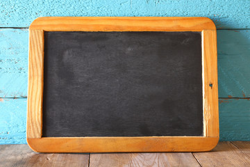 vintage wooden blackboard on wooden table with space for text