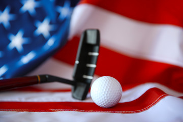 Golf ball and club on background of American flag. Popular sport concept