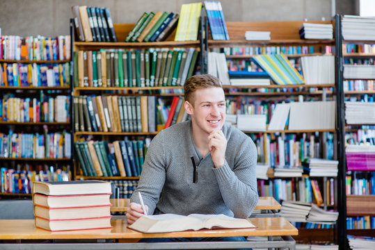 Portrait male student in a library