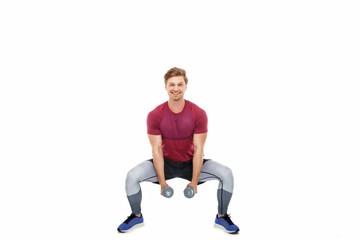 Obraz premium A man in a sportswear with dumbbells.